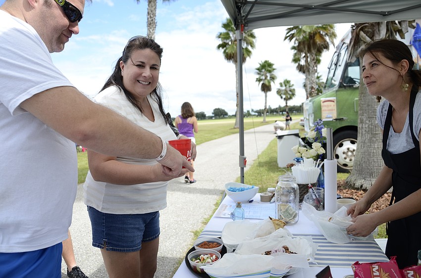 Dan Bozenka and Stacey Valahakis order some gyros from Eleftheria Skella with Blu Kouzina.