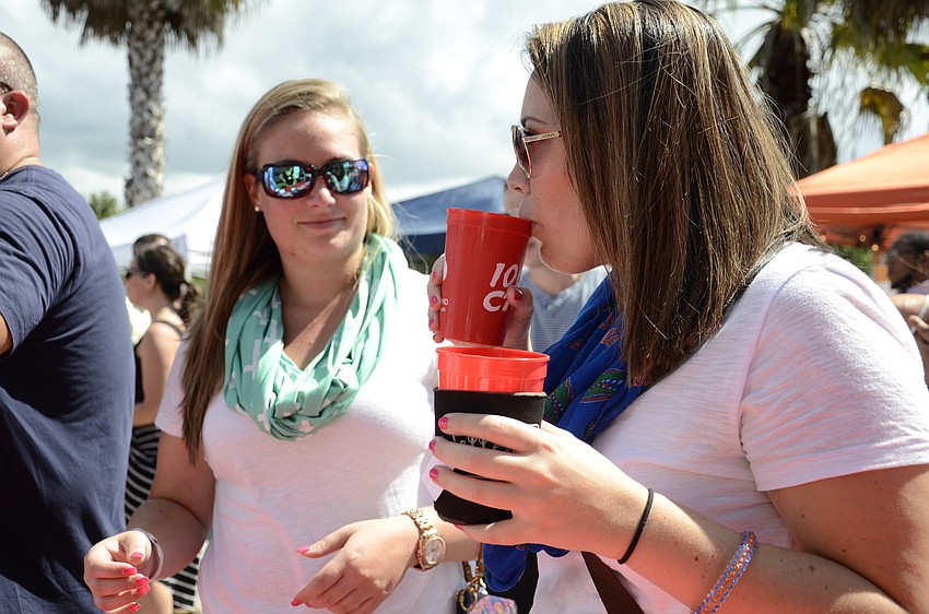 Sara Hien and Danielle Frey taste each other's beers. Their favorite was the pumpkin wheat from Shocktop.