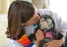 Associate Rector for St. Boniface Andi Taylor gives Gracie a smooch after a blessing.