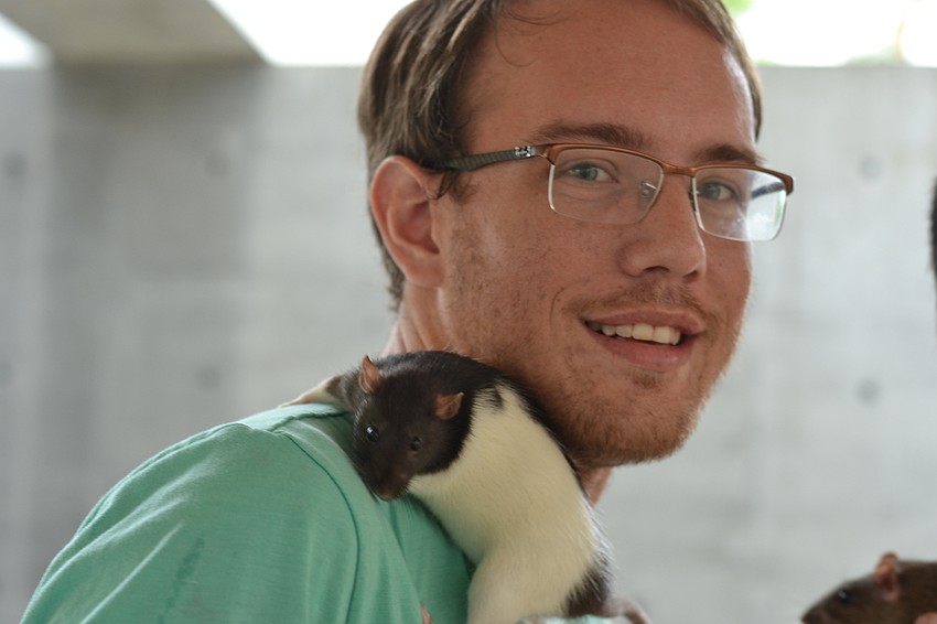 Charlie Farrell with one of two rats that he brought to be blessed at St. Boniface.