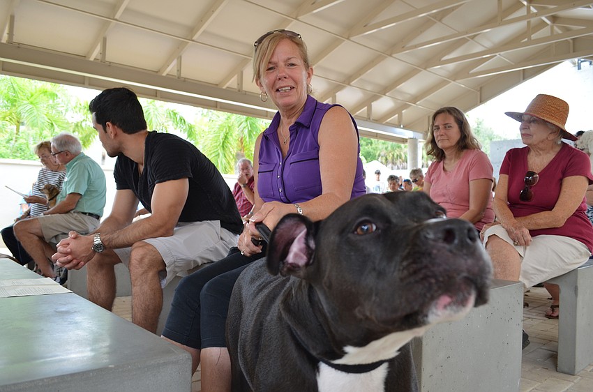 Enzo a six-year-old mix waits to be blessed with Lisa Lampel.