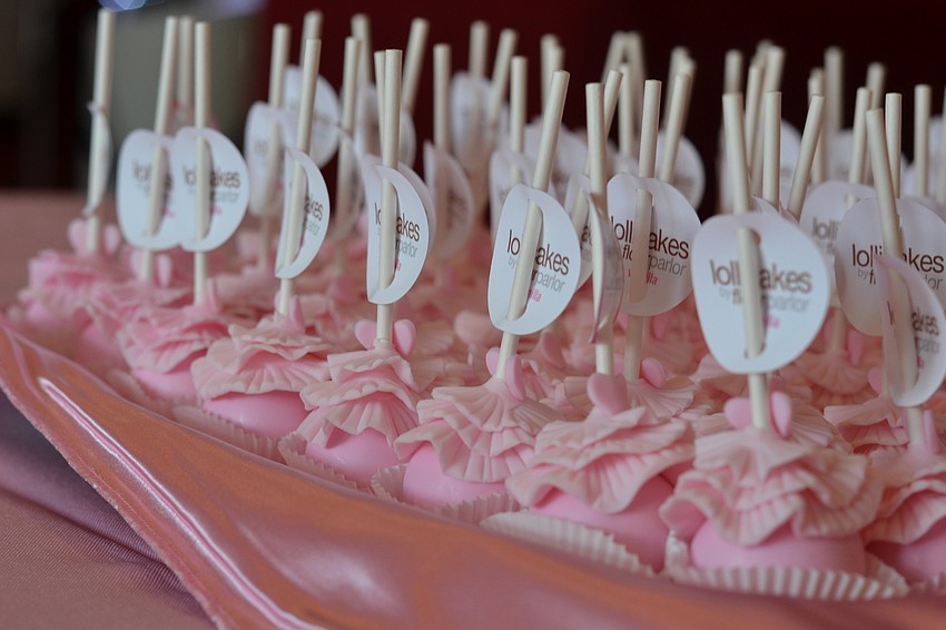 Lollicakes with pink tutu's wait for guests to take home as favors.