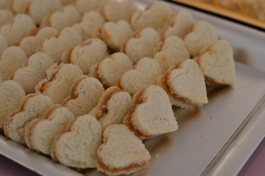 Heart-shaped peanut butter and jelly tea sandwiches.