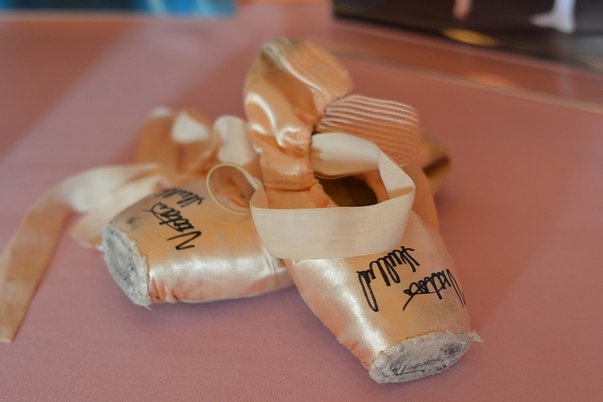 A pair of pointe shoes signed by Sarasota Ballet Principal Dancer Victoria Hulland.