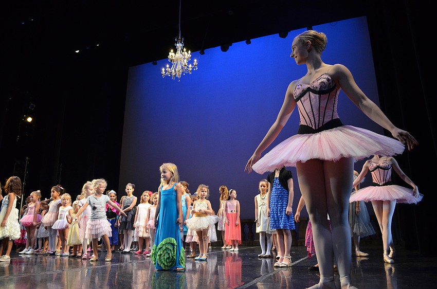 Sarasota Ballet dancer Caitlin Gish leads young dancers on the stage at the FSU Center for the Performing Arts.
