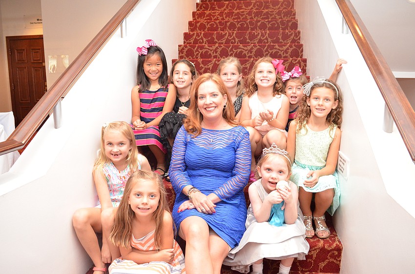 Event Chair Retta Wagner sits with some of the young ballet enthusiasts.