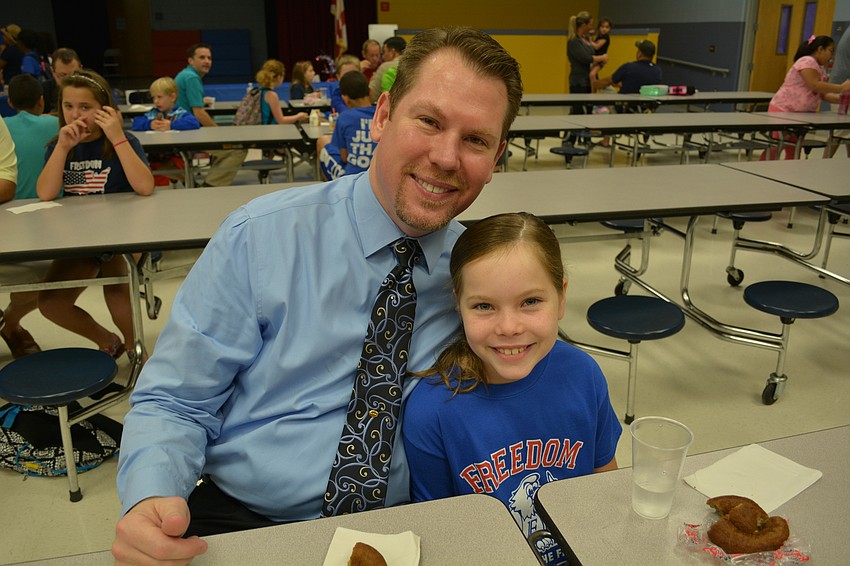 Scott Martin attends with his daughter, Delaney, 8.