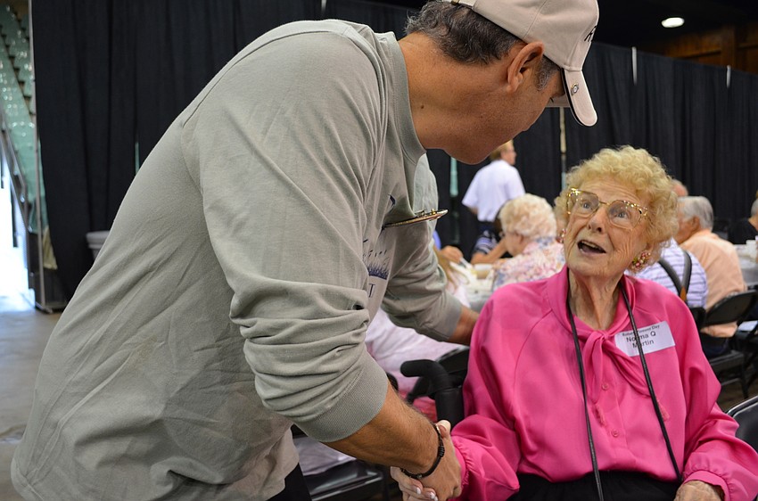 Rotary Club of Sarasota President Vicente Medina greets one of the oldest pioneers Norma Martin.