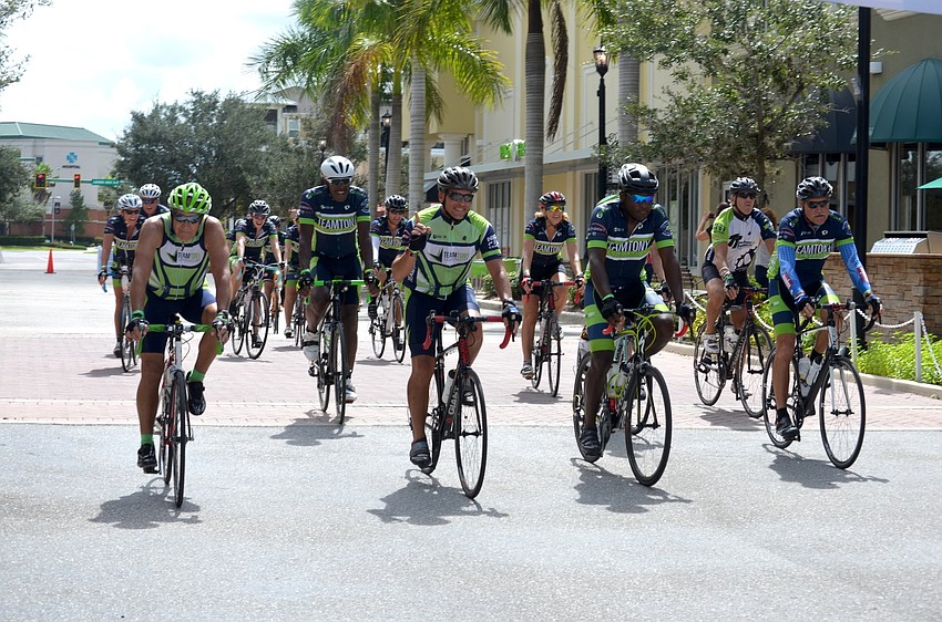 Hundreds of riders arrive on bicycles to a finishing party a Lakewood Ranch Main Street.