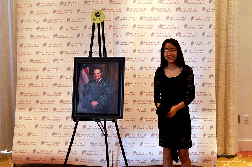 Ringling College of Art and Design student Grace Cheung unveils her portrait during the VIP Reception at Ringling College Library Association’s Town Hall 2015 Platinum Appreciation Dinner.