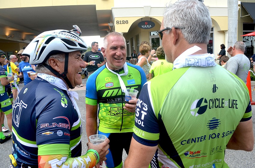 Carlos Borge, Gregory Arnott and Gary Rogers exchange stories while sipping on cold refreshments after the event.