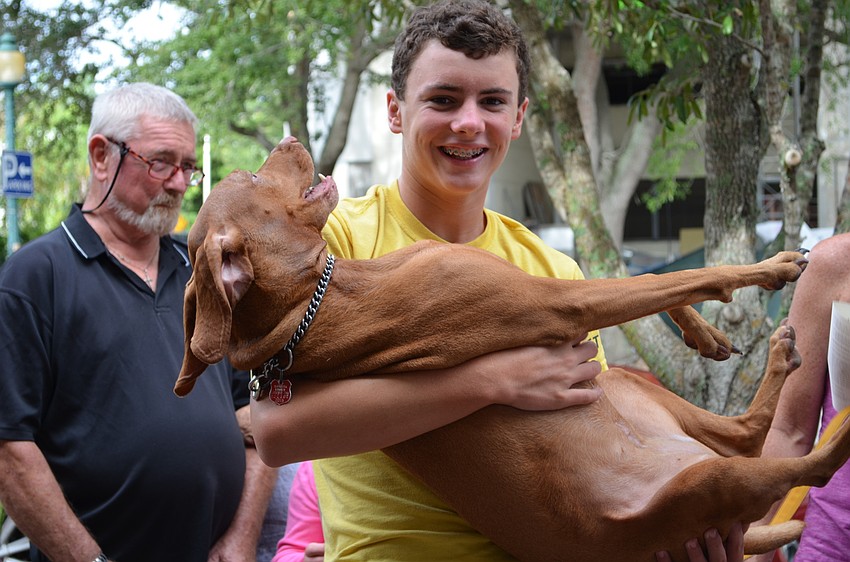 Conner Shoemaker holds Bella during the Animal Blessing service.