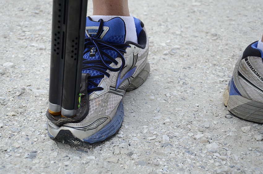 Norman Webster rests his gun on a foot pad.