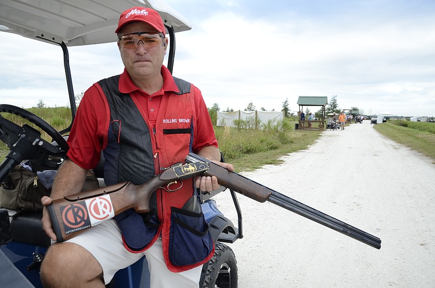 Rollins Brown shows his $60,000 Kreighoff with hand-detailed gold metalwork.