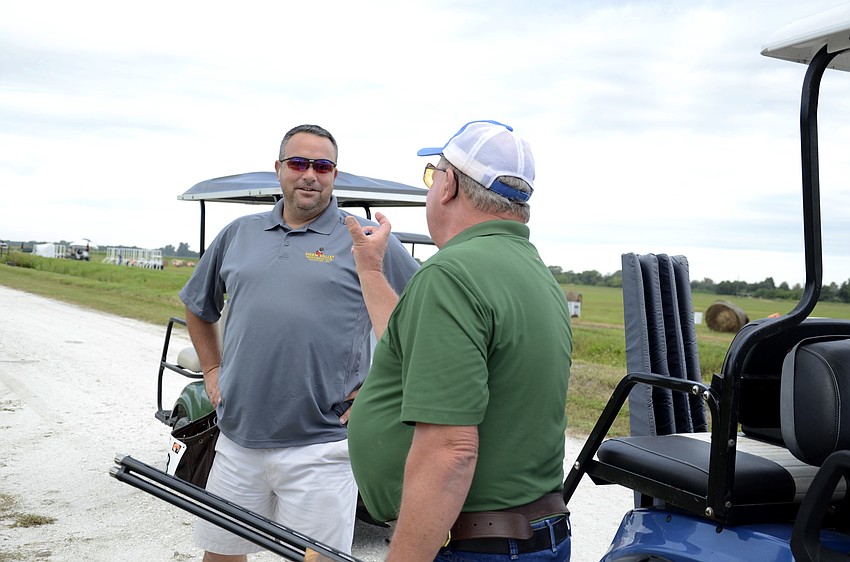 Ken Patton, right, tells Kirk Gardner how close he was to hitting a clay.