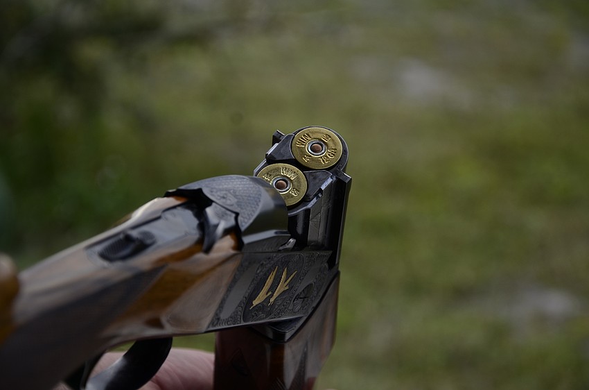 Ken Patton loads shells before his turn.