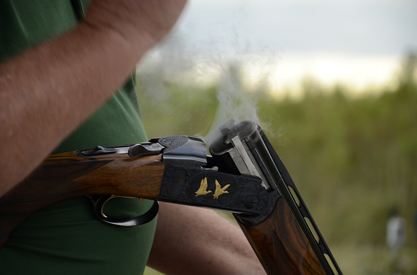 Ken Patton's shotgun smokes after he shoots a round.