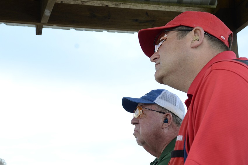 Ken Patton and Rollins Brown watch their shooting mate, Kirk Gardner, on his round.
