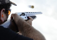 Jordan Blanton's shotgun shell flies after he shoots a clay.