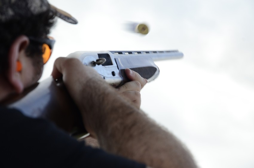 Jordan Blanton's shotgun shell flies after he shoots a clay.