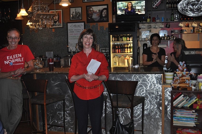 Eileen Normile addresses guests at her watch party at Word of Mouth cafe.