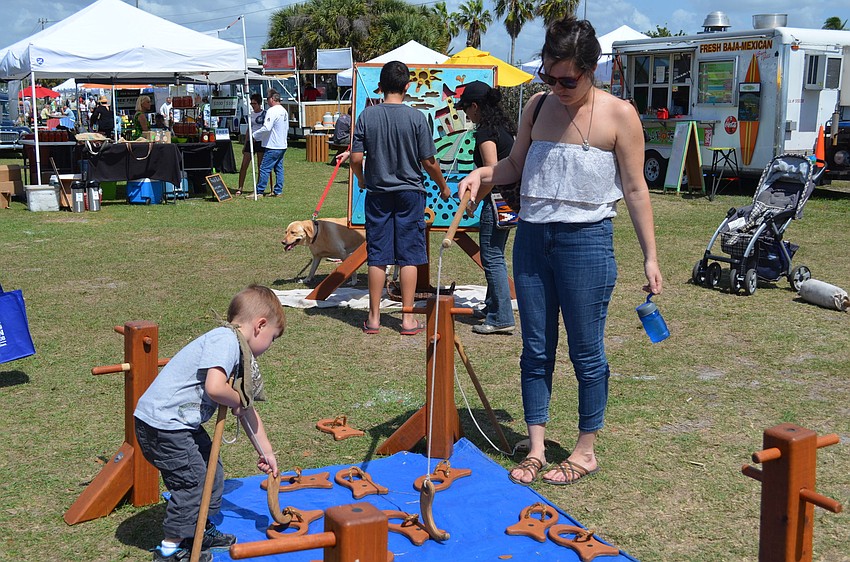 Megan Swick plays a fishing game with her son Bernard.
