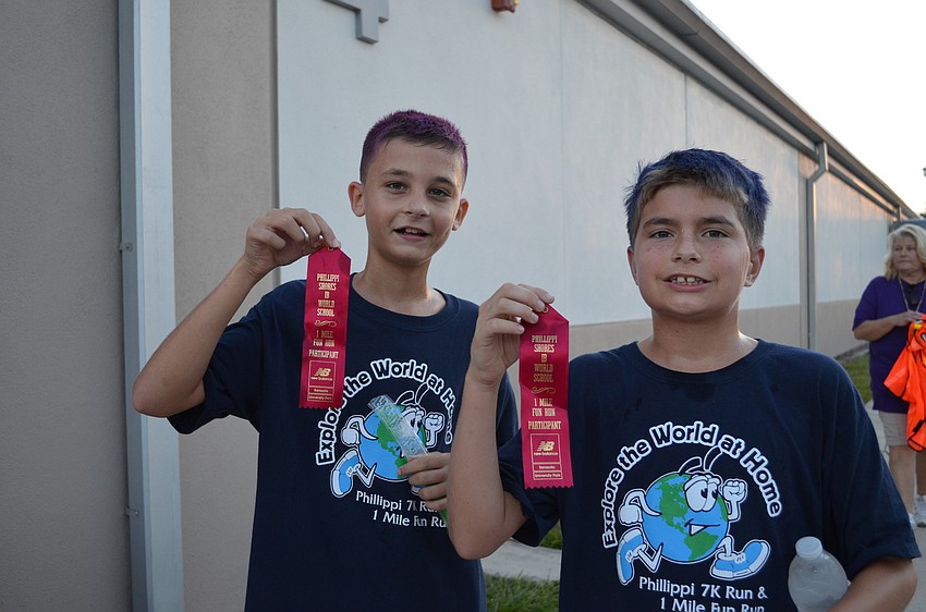 Cayman Reisky and John Cox ran together in the 1-mile Fun Run and finished first and second, respectively.
