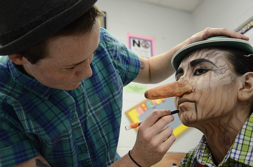 Casey Kelley completes the Pinocchio makeup for Natasha Harlin.