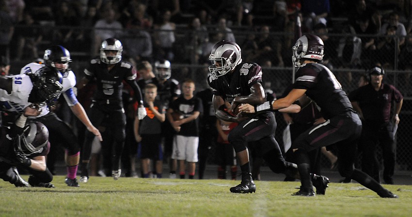Riverview quarterback Dominic Caldwell hands the ball off to Ali Boyce during the Rams opening possession.