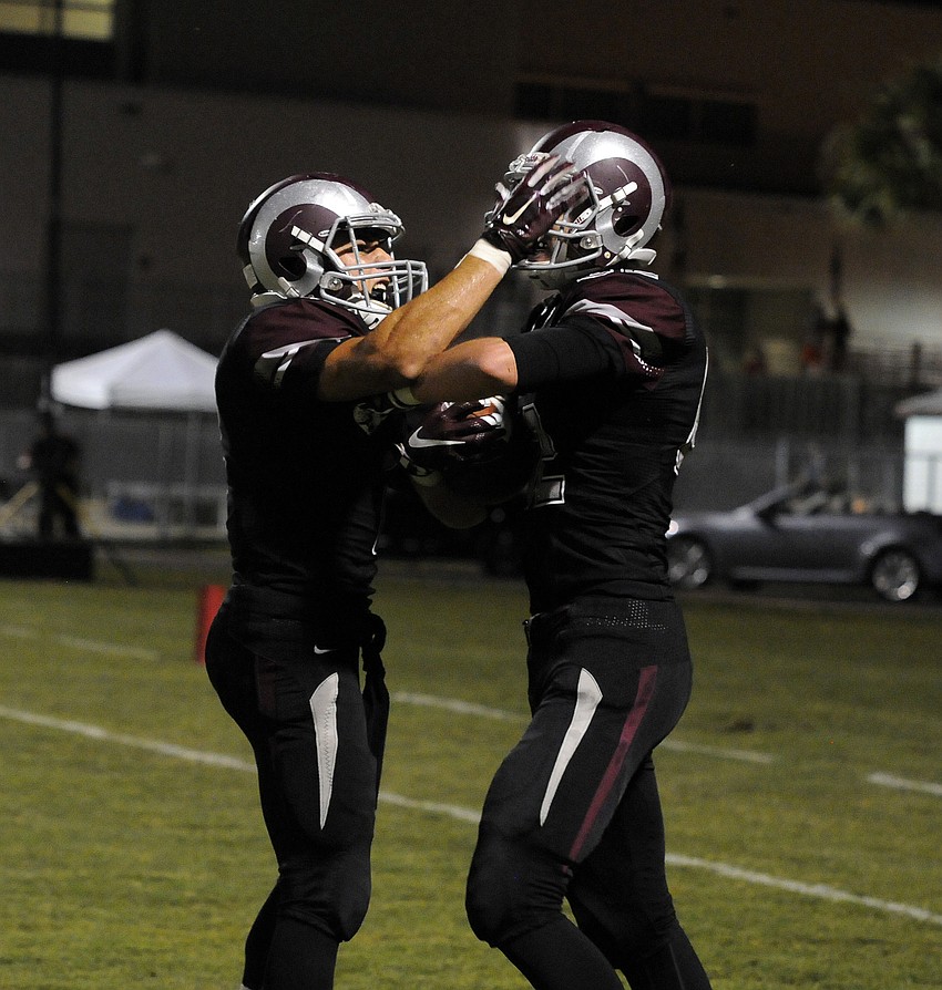 Andrew VanNess congratulates Riley Matthews following Matthews' touchdown catch.