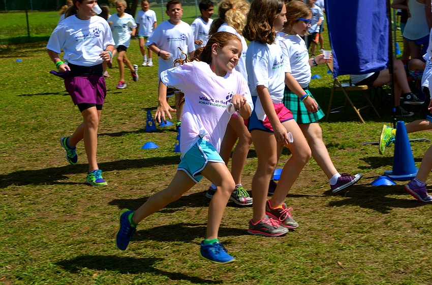 Ten-year-old Sydney Sprague leads a lap around the field.