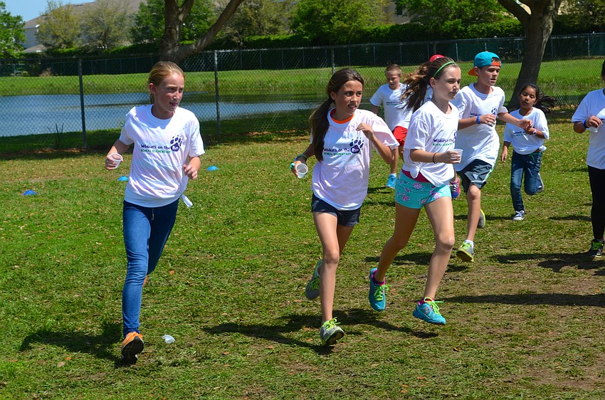 Andrea Dietz, Daniela Coughram and Darcey Bullas stay side-by-side throughout the Fun Run.