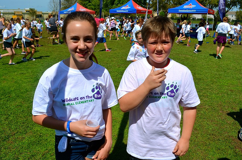 Angelina Frazzoni and Aidan Carroll visit the water booth after each lap.