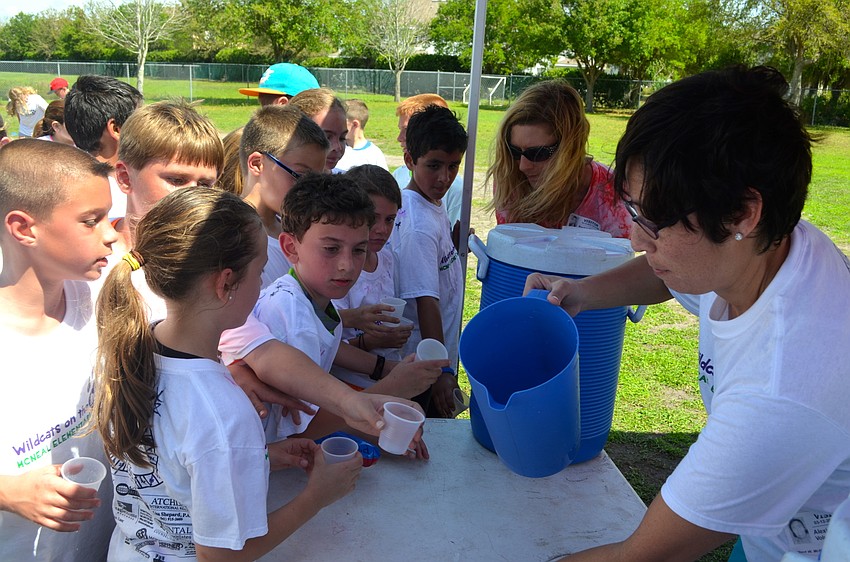 Alexis Morehead serves up cold water to thirsty children.