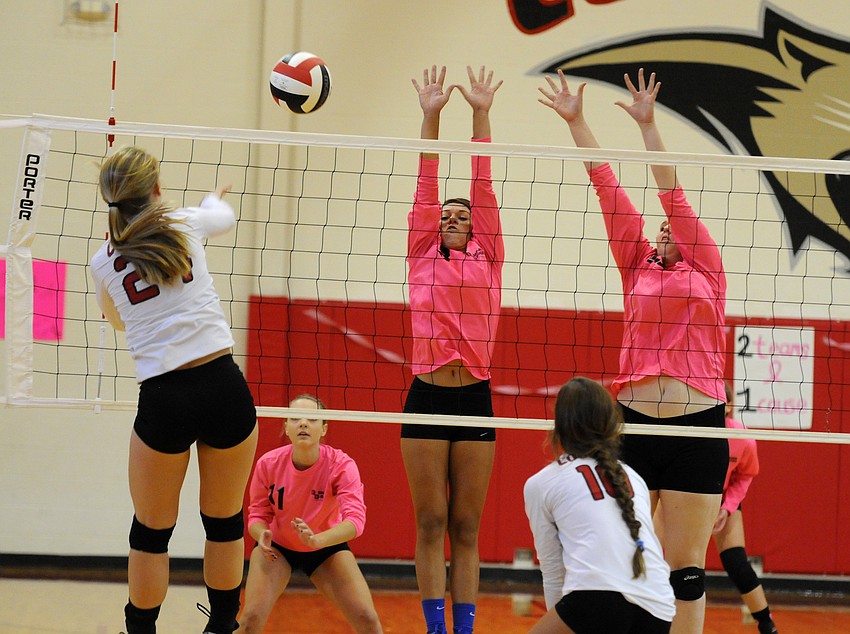 Sarasota Christian's Nicole Miller and Anikka Jensen go up for a block in the second set.