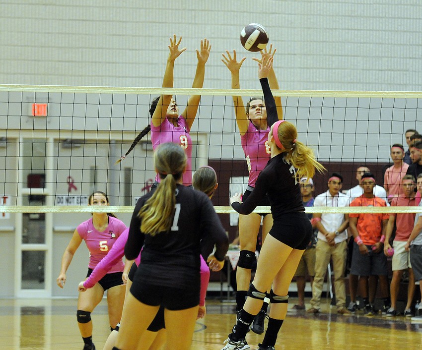 Sarasota's Emily Sauceda and Hannah Hritz go up for a block in the first set.