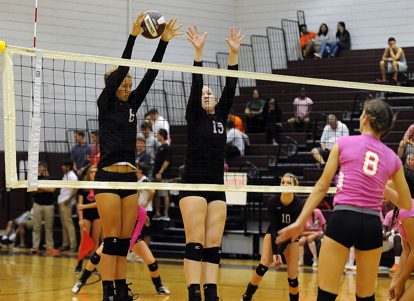 Freshman Alex Hilton and senior Sarah Neill go up for a block in the second set.
