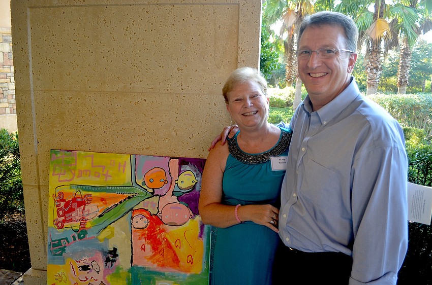 Mary and Brian Smith admire a painting by a resident of Community Haven.