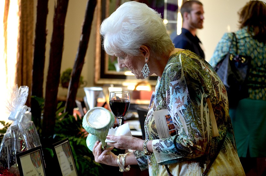 Sharon Leftwich, a parent of a Community Haven participant, looks through the silent auction items.