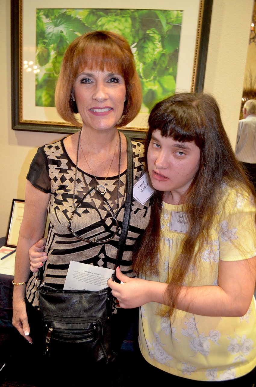 Sammy Markens and her daughter, Sarah, find their way to the snack table.