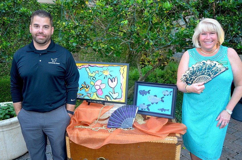 Communty Haven's Vice President of Operations Brad Jones and CEO Marla Doss show off props aligned with the multi-cultural theme.