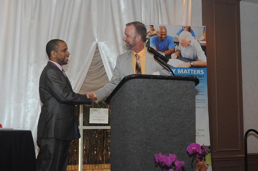 Jeffery Kin, the master of ceremonies and artistic director of Players Theatre, welcomes Denis Rodriguez.