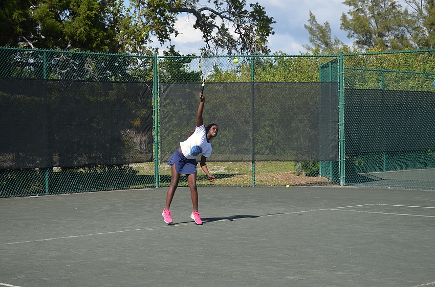 Jennifer Ibeto, 12, serves.