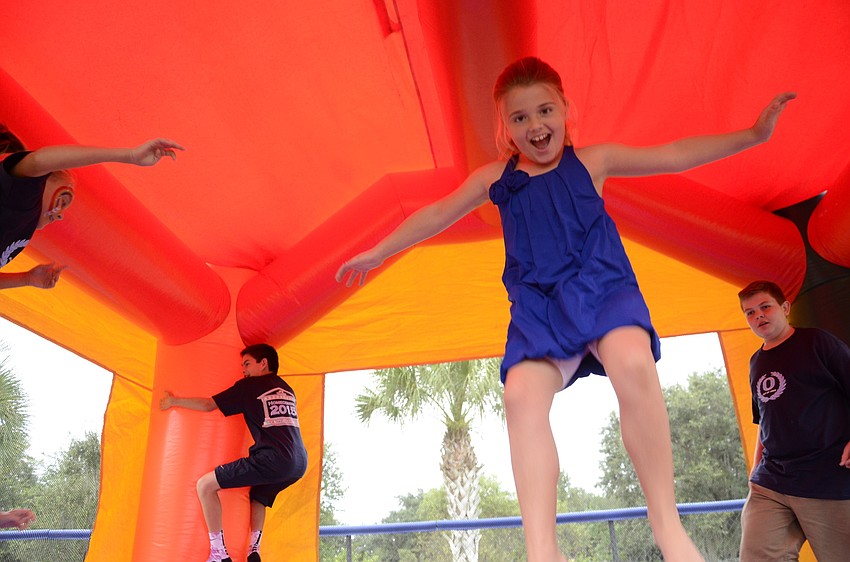Alexa Gettel, third-grader, gets some air in the bounce house.