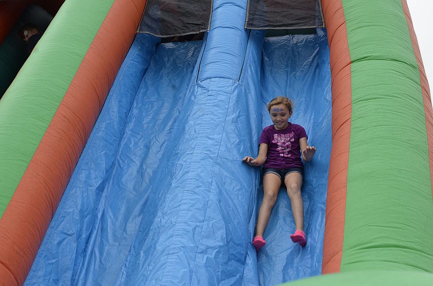 Charlie Hugill goes down the inflated slide.