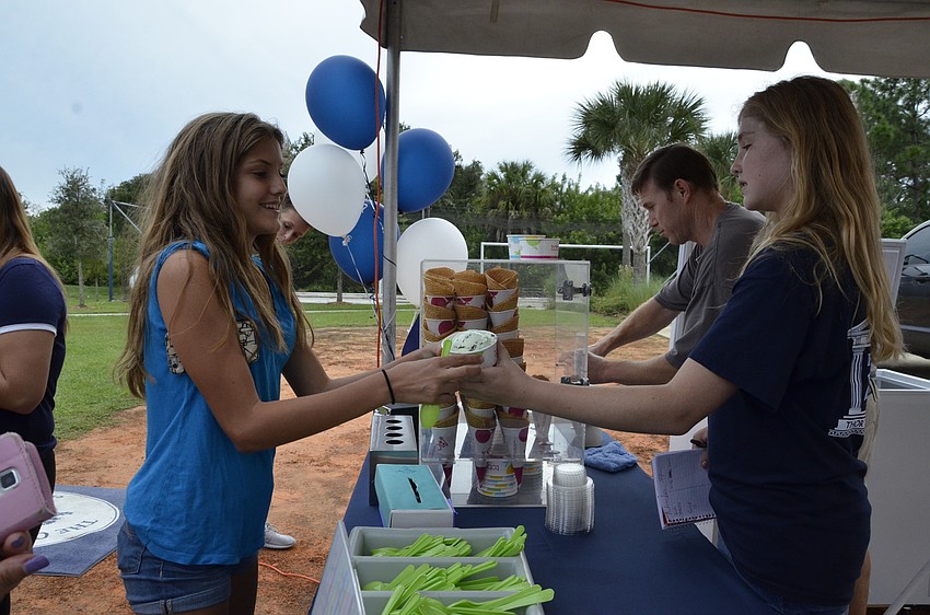 Elle LaClaire buys TCBY Frozen Yogurt from Hayley Latta. The eighth-graders got 20% of the profits from yogurt sales to raise money to take the grade to Washington D.C. for the annual field trip.