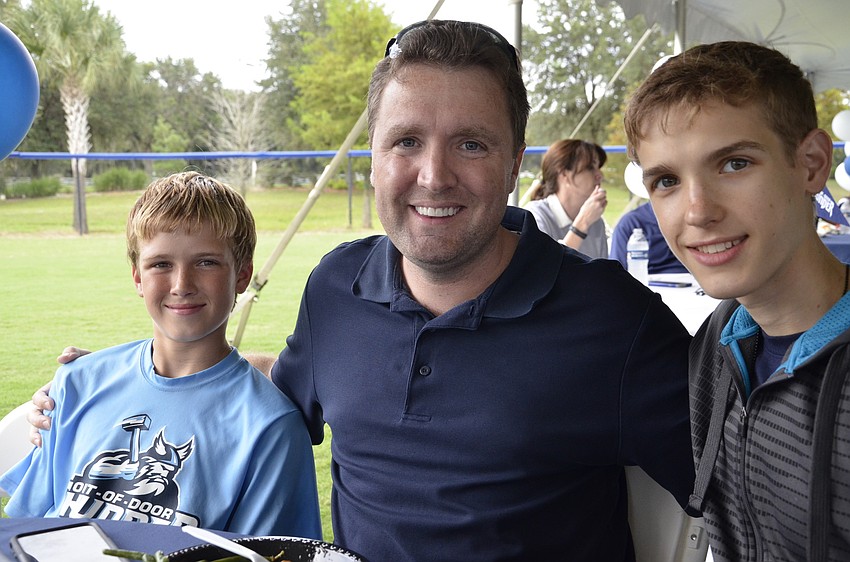 Chester Flake with his two sons, Jacob, left, and Ethnan, right.
