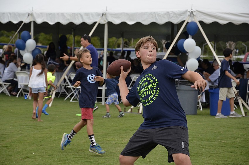 Seventh-grader Michael Dyer throws the ball to friends at the family picnic.