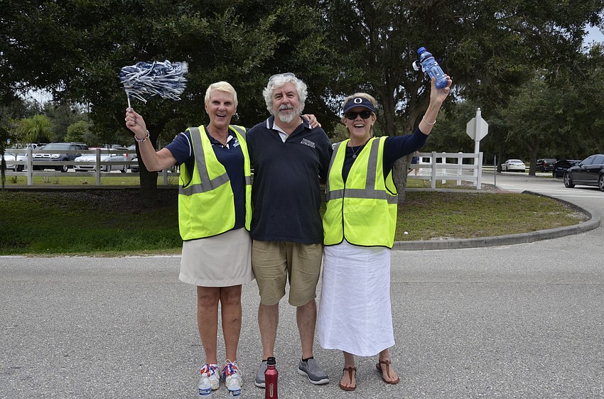 Renne Pitts, Paul Lebras and Martha Duffy, teachers at the Upper and Lower Schools, help direct traffic.