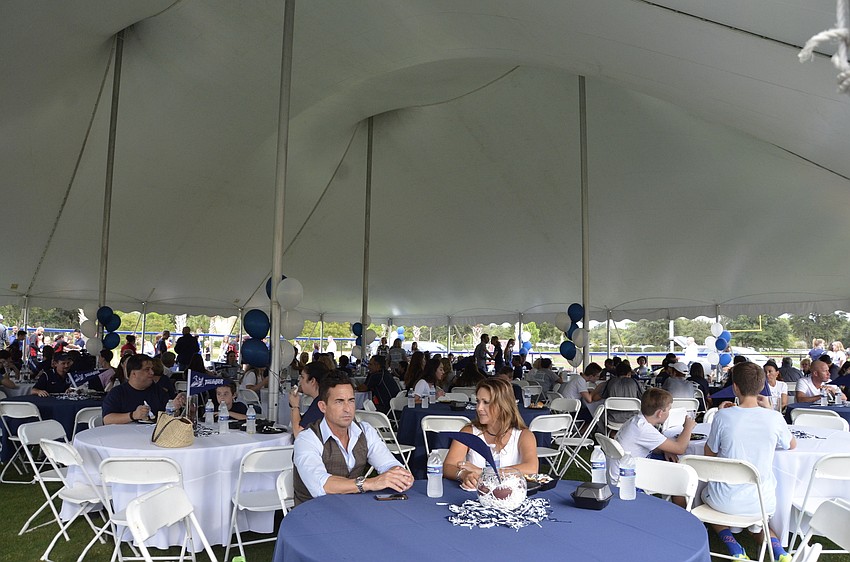 Families dined under a tent at the family picnic.